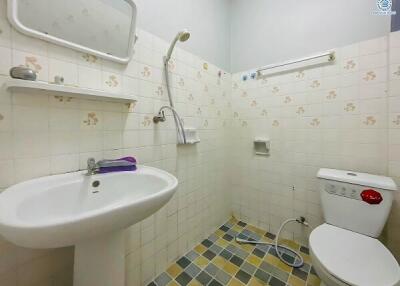 Compact bathroom with essential fixtures and tiled flooring