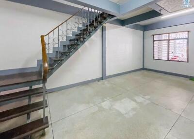 Empty residential interior with staircase and tiled flooring