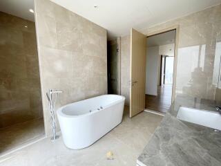 Spacious modern bathroom with a freestanding tub and large tiles