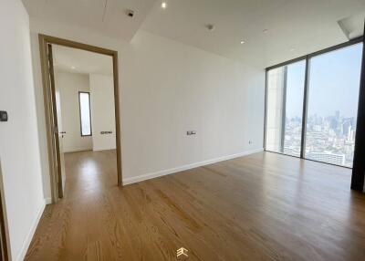 Spacious unfurnished living room with large windows and wooden flooring