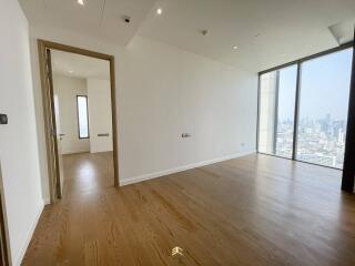 Spacious unfurnished living room with large windows and wooden flooring