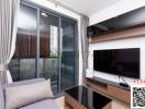 Modern living room with sliding doors to the balcony, featuring a flat-screen TV and a comfortable couch