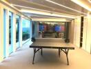 Spacious modern recreational room with ping pong table and ambient lighting