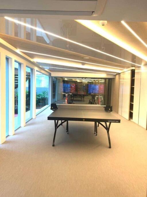 Spacious modern recreational room with ping pong table and ambient lighting