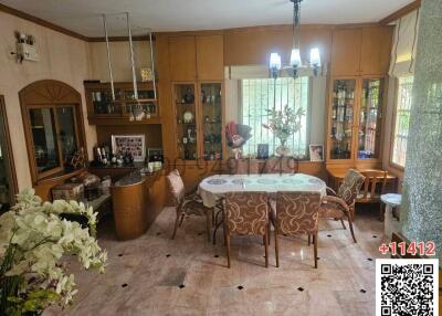 Spacious dining room with marble flooring and wooden cabinets