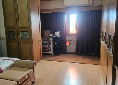 Bright living room with hardwood floors and large windows