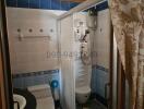 Compact bathroom with shower cabin, toilet and patterned tiles