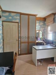 Home office with cloud-patterned wallpaper and wooden furniture