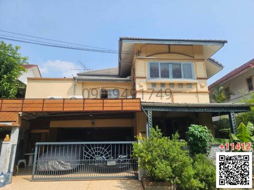 Contemporary two-story house with gated carport and balcony