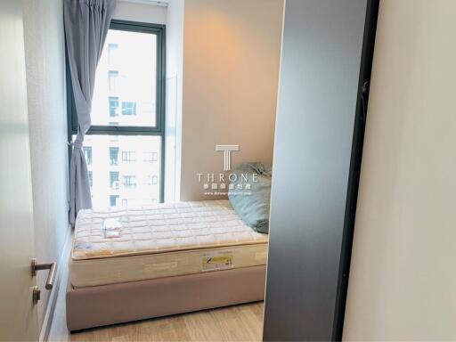 Compact bedroom with natural light and city view