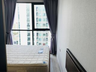 Modern bedroom with large window and city view