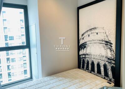 Modern bedroom with large wall art and city view