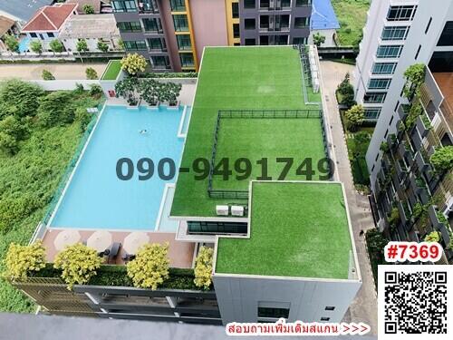 Aerial view of residential building with pool and green space