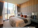 Modern bedroom with large windows and city view