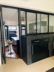 Modern kitchen with black cabinetry and stainless steel appliances