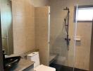 Modern bathroom with walk-in shower and neutral tile