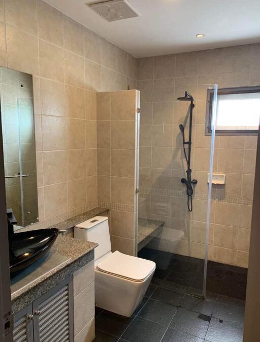 Modern bathroom with walk-in shower and neutral tile