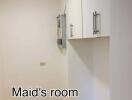 Compact maid's room with built-in cabinets