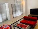 Cozy living room with red sofa and modern amenities