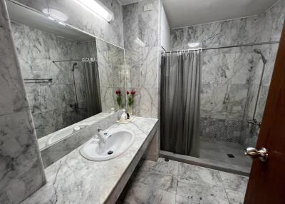 Modern bathroom with marble tiles and glass shower