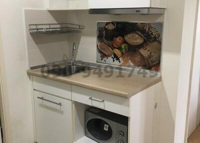 Compact modern kitchen with microwave and sink