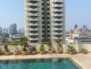 Urban balcony overlooking a pool and neighboring high-rise buildings