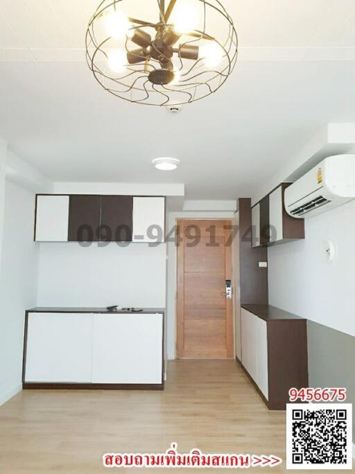 Modern compact kitchen in an apartment with wooden door and ceramic flooring