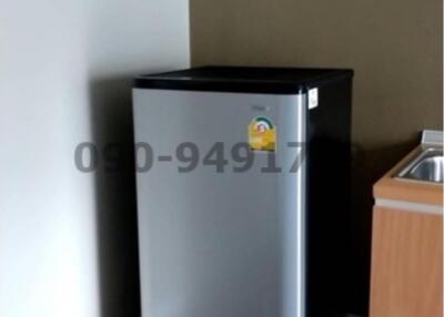 Compact fridge in the corner of a modern kitchen