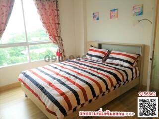 Cozy bedroom with striped bedding and natural light