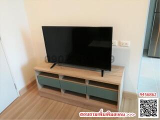 Modern living room with a large flat-screen TV on a wooden entertainment unit