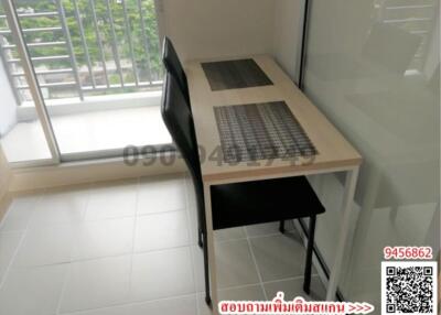 Compact office nook with desk and chair near window with natural light