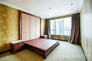 Spacious bedroom with large window and city view