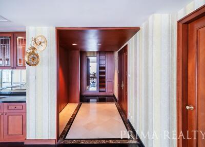 Elegant hallway interior with hardwood doors and tiled flooring