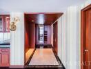 Elegant hallway interior with hardwood doors and tiled flooring