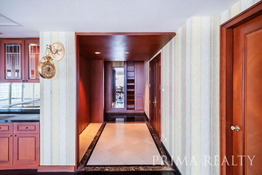 Elegant hallway interior with hardwood doors and tiled flooring