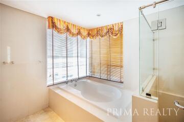 Spacious bathroom with a large tub and natural light