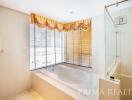 Spacious bathroom with a large tub and natural light