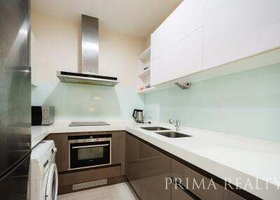 Modern kitchen with white countertops and stainless steel appliances