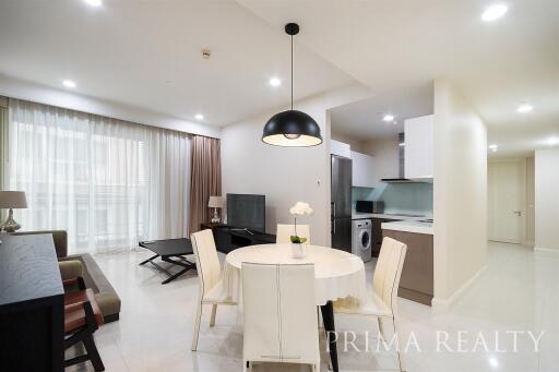 Spacious combined living room and kitchen area with modern furnishings