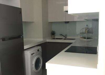 Modern kitchen with white cabinets and stainless steel appliances