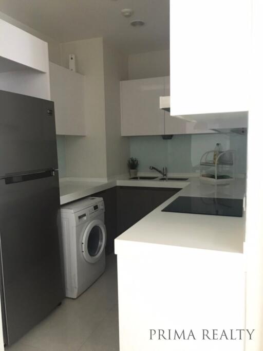 Modern kitchen with white cabinets and stainless steel appliances