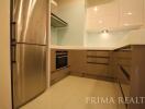 Modern kitchen with stainless steel appliances and built-in cabinets