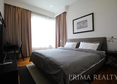 Modern bedroom with natural light and comfortable furnishings