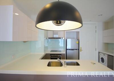 Modern kitchen with stainless steel appliances and black overhead lamp