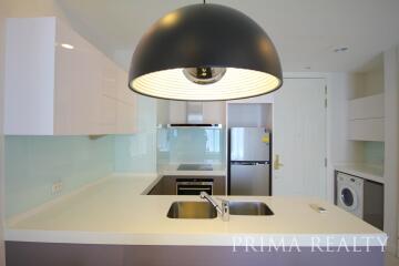 Modern kitchen with stainless steel appliances and black overhead lamp