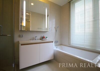 Modern bathroom with ample lighting and a bathtub