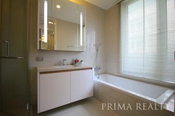 Modern bathroom with ample lighting and a bathtub