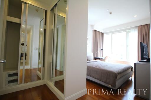 Modern bedroom with glass sliding doors and ample daylight