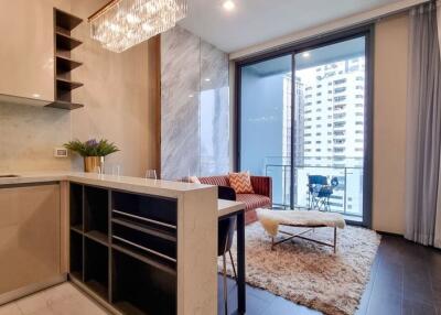 Modern kitchen with dining area and balcony access in a luxury apartment