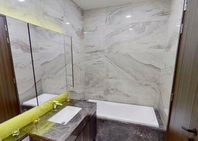 Modern bathroom with marble walls and LED lighting